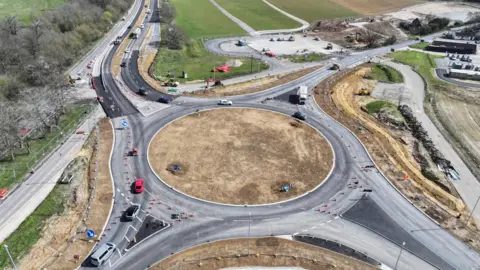 Sizewell C A drone image of a newly constructed roundabout. Vehicles can be seen going around the roundabout. 