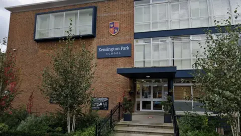Kensington Park School - a modern brick building with concrete steps up to glass front doors. The school name is on a sign on the wall.