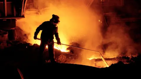 Construction Photography/Avalon A steelworker testing molten iron quality at Blast Furnace 4 in Port Talbot