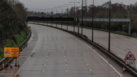 An empty m25 with roadwork signs