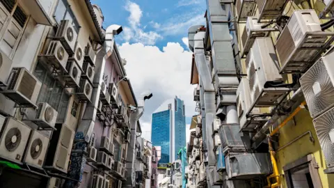 Getty Images An alley in Singapore lined with dozens of air conditioning units