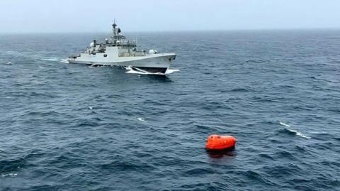 Indian Navy photo showing a warship approaching a lifeboat in the Arabian Sea
