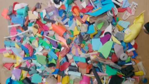 Weymouth and Portland Marine Litter Project A pile of tiny broken fragments of brightly coloured plastic.