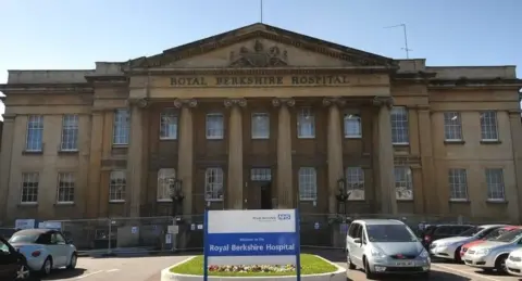 BBC Royal Berkshire Hospital building with blue and white NHS sign out the front in the car park.