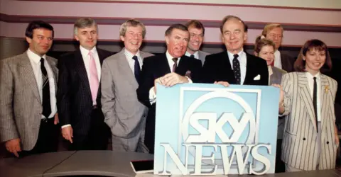 Getty Images  Tony Blackburn, Peter Marshall, Derek Jameson, Andrew Neil, Alastair Yates, Rupert Murdoch, Penny Smith, Bob Friends, Kay Burley during the launch of Sky TV on February 5, 1989 in London England