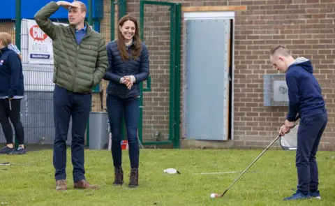 PA Media William and Kate watch a game of golf