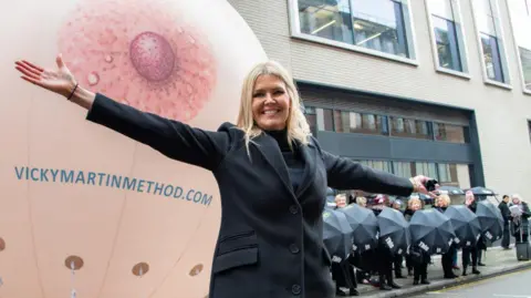 Vicky Martin Method Vicky Martin stood in front of giant inflatable breast