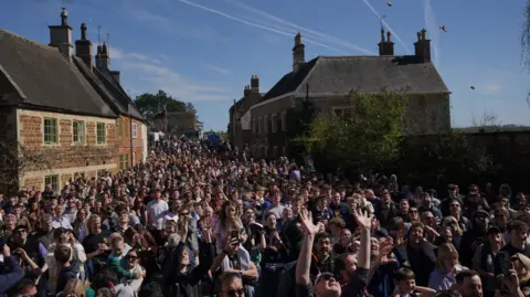 PA Media People gathering in Hallaton during a game of bottle kicking in Leicestershire