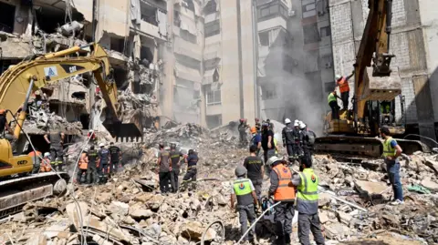 EPA Emergency workers usage  excavators to wide   the rubble astatine  the tract  which was targeted by an Israeli onslaught   the erstwhile   day, successful  the confederate  suburb of Beirut, Lebanon