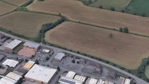 A field seen from above on the edge of a town