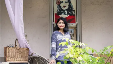 Jose Moreno Democrat Danielle Kwock Phillips - in front of house