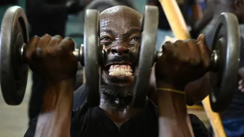 Getty Images A man lifts weights as he works out at the Kaloleni gym, in Nairobi, Kenya - Wednesday 9 January 2019