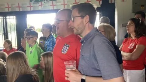 Jenny Kirk/BBC MP Duncan Baker watching World Cup final at North Walsham