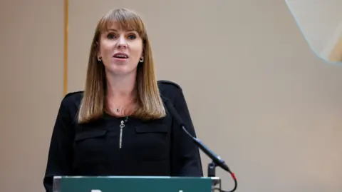 Angela Rayner standing at a lectern