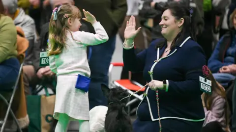 Lydia Mellor Mother and daughter giving each other a high-five