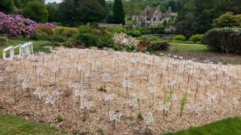 Leanne Rinne/BBC A display of steel butterflies installed at Scotney Castle grounds.