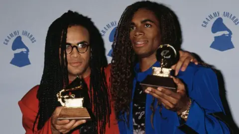 Getty Images Milli Vanilli pose with their Grammy trophies in 1990