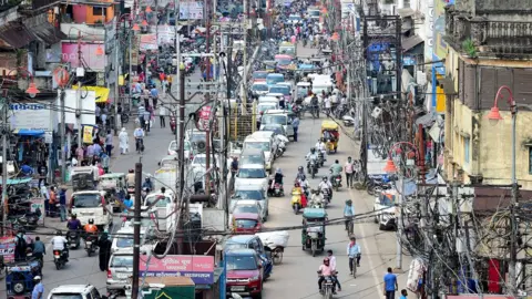 Getty Images Commuters are seen along a road in the old neighbourhood of Chowk, in Allahabad on August 17, 2020.