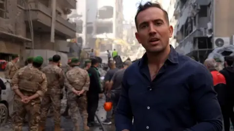 BBC Middle East correspondent Hugo Bachega at scene of destroyed building in Beirut, Lebanon