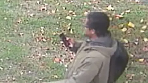 Metropolitan Police/PA Media Screen shot from CCTV issued by Metropolitan Police of Terror suspect Ali Harbi Ali walking between Leigh-on-Sea railway station, and Belfairs Methodist Church wearing khaki jacket, black trousers and black backpack