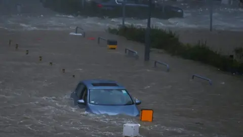 Reuters A car is stranded in seawater as high waves hit the shore during Typhoon Mangkhut at Heng Fa Chuen in Hong Kong, China on 16 September 2018.