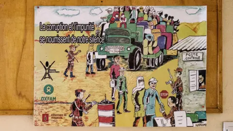 Getty Images A poster against corruption from migrants pinned to a notice bored in the reception of the ministry of interior and decentralisation in Agadez, Niger - 23 January 2023