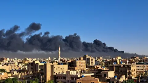 Getty Images Smoke billows over the Sudanese capital Khartoum