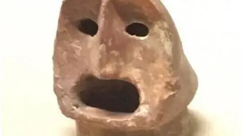 Shaanxi History Museum Pottery statue of a man's head, neolithic era, on display at Shaanxi History Museum