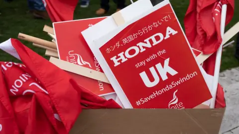 Dan Kitwood/ Getty Images Honda placards after a protest against the plant's closure