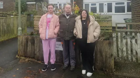 Lola Ebury Jason Ebury stood alongside his kids outside their home