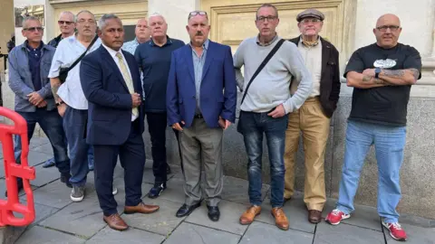 10 men standing outside Bristol Crown Court