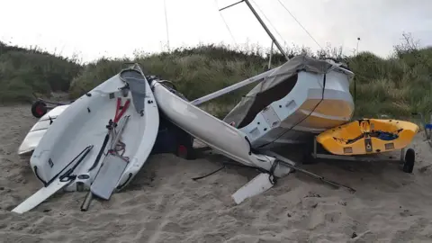 Isles of Scilly Sailing Club Boats battered on the beach