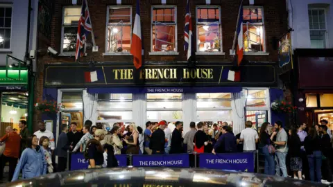 LDRS Revellers outside a central London pub called the French House