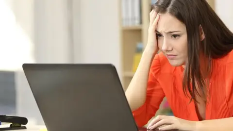 Getty Images Stressed lady at computer