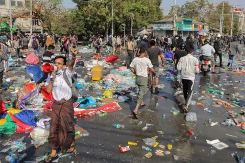 Reuters Demonstrators riot against police as they protest against the military coup and to demand the release of elected leader Aung San Suu Kyi, in Mandalay, Myanmar, February 9, 2021.