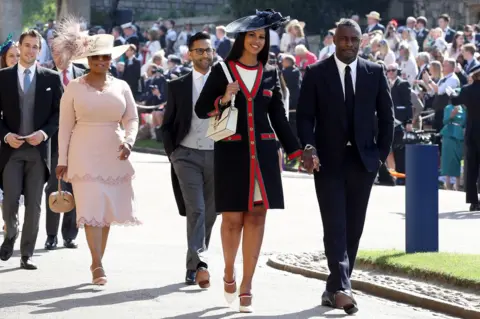 PA Idris Elba and Sabrina Dhowre, followed by Oprah Winfrey, arrive at St George's Chapel