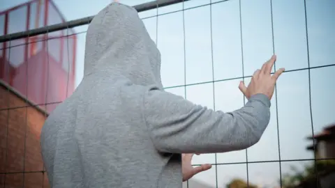 Getty Images Stock image of hooded teen