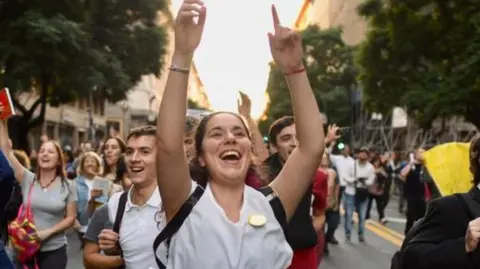 A woman dances during protests against university cuts in Buenos Aires.