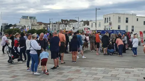 Dawid Wojtowicz/BBC People attending a vigil for Archie Battersbee