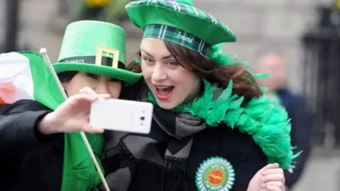 EPA/AIDAN CRAWLEY Two women take a selfie during the St Patrick's Day Parade in Dublin, Ireland, 17 March 2017