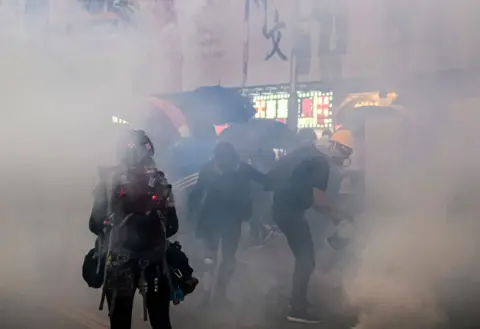 Getty Images Police fire tear gas at protesters in Hong Kong