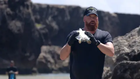 Royal Navy a man carrying a turtle