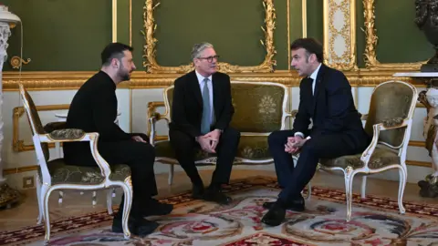 EPA Ukraine President Volodymyr Zelensky, Prime Minister Keir Starmer and French President Emmanuel Macron  holding a meeting in Lancaster House