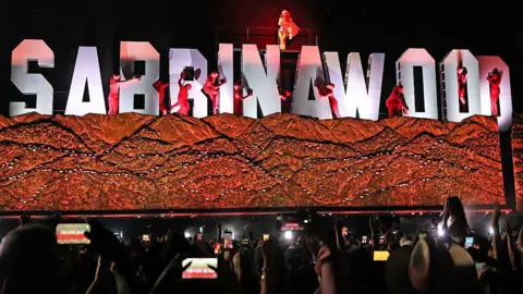 Kevin Mazur/Getty Images for Coachella Sabrina Carpenter performs at the Coachella Stage during the 2026 Coachella Valley Music and Arts Festival at Empire Polo Club on April 10, 2026 in Indio, California. 