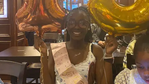 Jacobs family Hannah Jacobs with 13th birthday sash and baloons