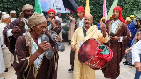  Jihed Abidellaoui/Reuters An image of men dancing and playing instruments to celebrate Prophet Muhammad's birthday in Tunis, Tunisa - Sunday 15 September 2024.