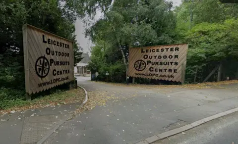 Google Large Outdoor Pursuits Centre signs on either side of a driveway