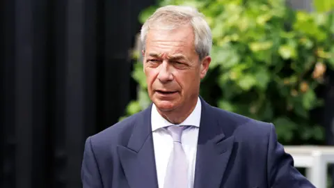  Reform UK leader Nigel Farage drinks a pint in a pub on July 08, 2026 in Great Bentley, England.