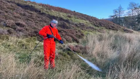 A ‘fogging’ machine being demonstrated attached to an all-terrain vehicle