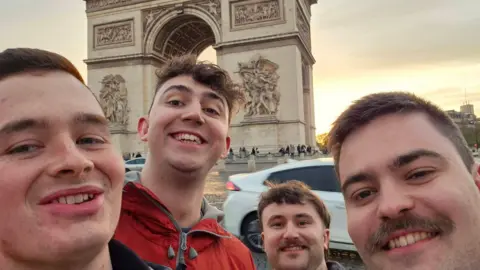 Erewash Borough Council Harry Atkinson and friends stood taking selfie next to Arc de Triomphe